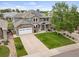 Beautiful two-story home featuring stone accents, solar panels, a two-car garage, and a well-manicured front yard at 9467 W Plymouth Ave, Littleton, CO 80128