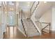 Two story foyer with hardwood floors and staircase to second level at 9467 W Plymouth Ave, Littleton, CO 80128