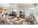 Open-concept living area with a fireplace, hardwood floors, and seamless connection to dining and kitchen spaces at 9467 W Plymouth Ave, Littleton, CO 80128