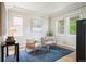 Cozy sitting area with natural light, neutral decor, and a blue rug at 9467 W Plymouth Ave, Littleton, CO 80128