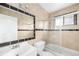 Bathroom with tile accents, a bathtub/shower combo, and a vanity sink at 14190 E Gunnison Pl, Aurora, CO 80012