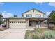 Charming two-story home with stone accents, a two-car garage, and a well-maintained front yard at 14190 E Gunnison Pl, Aurora, CO 80012