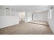 Bright living room with neutral carpeting, white walls, and a spacious layout at 14190 E Gunnison Pl, Aurora, CO 80012