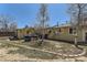 A backyard has mature trees and landscaping, a shed, utilities, and ample patio and yard space at 15645 E Floyd Ave, Aurora, CO 80013