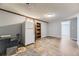 A basement area features a refrigerator, storage, access to another room, and carpeted and wood-look flooring at 15645 E Floyd Ave, Aurora, CO 80013