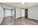 A finished basement features wood-look flooring, two closets, and access to other parts of the home at 15645 E Floyd Ave, Aurora, CO 80013