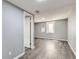 The basement features wood-look flooring, a small window, and access to the home's upper levels at 15645 E Floyd Ave, Aurora, CO 80013