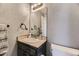 Compact bathroom with a vanity, mirror, and modern fixtures at 15645 E Floyd Ave, Aurora, CO 80013