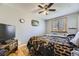 Comfortable bedroom with a ceiling fan, a window, and a cozy bed at 15645 E Floyd Ave, Aurora, CO 80013