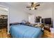 Spacious bedroom with a ceiling fan, wood floors, and comfortable furnishings at 15645 E Floyd Ave, Aurora, CO 80013
