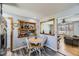 Cozy dining area features a round table, four chairs, and rustic wood trim around a decorative pass-through at 15645 E Floyd Ave, Aurora, CO 80013