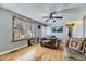 A comfy living room with hardwood floors, ceiling fan, and nice view out of the large window at 15645 E Floyd Ave, Aurora, CO 80013