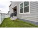 Backyard of the property is fenced and features a small patio with artificial turf for a low-maintenance lawn at 5152 Bittercress Rd, Brighton, CO 80640