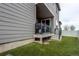 Back of house with patio, stairs to the backyard, and new artificial turf at 5152 Bittercress Rd, Brighton, CO 80640