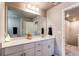Bright bathroom features a quartz countertop, updated fixtures, and decorative accents at 5152 Bittercress Rd, Brighton, CO 80640