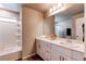 Bright bathroom features a tiled shower and tub, a quartz countertop and updated fixtures at 5152 Bittercress Rd, Brighton, CO 80640