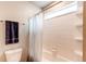 This bathroom features a shower and tub with tiled walls and a shower caddy for toiletries at 5152 Bittercress Rd, Brighton, CO 80640