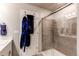 Bathroom features a glass-enclosed shower and blue decorative elements on the door at 5152 Bittercress Rd, Brighton, CO 80640