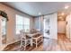 Dining room with table, chairs, bench seating and sliding door to outdoor patio at 5152 Bittercress Rd, Brighton, CO 80640