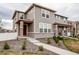 Charming two-story home with neutral siding, brick accents, a walkway and manicured landscaping at 5152 Bittercress Rd, Brighton, CO 80640