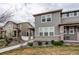 Two-story home with neutral siding, brick accents, a walkway and landscaping in a neighborhood at 5152 Bittercress Rd, Brighton, CO 80640