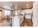 Bright, white kitchen with island seating, stainless appliances, and open to the dining area at 5152 Bittercress Rd, Brighton, CO 80640