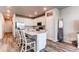 Bright, modern kitchen with stainless steel appliances, quartz countertops, and wood floors at 5152 Bittercress Rd, Brighton, CO 80640