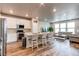 Open floor plan features a modern kitchen, large island, and cozy living room at 5152 Bittercress Rd, Brighton, CO 80640