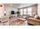 Cozy living room with wood floors, neutral paint, and bright, natural light at 5152 Bittercress Rd, Brighton, CO 80640