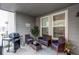 Relaxing covered patio with wicker furniture, stylish decor, and outdoor grill at 5152 Bittercress Rd, Brighton, CO 80640