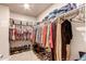 Spacious walk-in closet featuring multiple racks and shelving units for ample storage at 5152 Bittercress Rd, Brighton, CO 80640