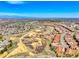Picturesque aerial view of a vibrant community with red-roofed homes nestled in a natural landscape with winding trails at 9588 Firenze Way, Highlands Ranch, CO 80126