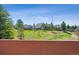 Backyard view with lush greenery and a sprawling lawn, perfect for outdoor enjoyment at 9588 Firenze Way, Highlands Ranch, CO 80126