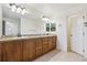 Bathroom featuring a vanity with double sinks, a large mirror, and tile floors at 9588 Firenze Way, Highlands Ranch, CO 80126