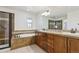 Bathroom featuring a vanity with double sinks, a soaking tub, and a glass-enclosed shower at 9588 Firenze Way, Highlands Ranch, CO 80126