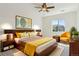 Bedroom with a large bed, wood nightstands, and a window overlooking the neighborhood at 9588 Firenze Way, Highlands Ranch, CO 80126