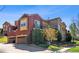 Beautiful residence showcasing a blend of stone and stucco, a balcony, and an attached garage with a paver driveway at 9588 Firenze Way, Highlands Ranch, CO 80126