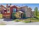Charming home featuring a stone and stucco facade, balcony, attached garage, and well-maintained landscaping at 9588 Firenze Way, Highlands Ranch, CO 80126