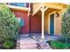 Charming home entrance with well-manicured landscaping, stone steps, and a inviting front door at 9588 Firenze Way, Highlands Ranch, CO 80126