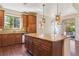 Spacious kitchen features a large center island with granite countertops, stainless appliances, and sleek hardwood floors at 9588 Firenze Way, Highlands Ranch, CO 80126