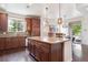 Spacious kitchen with dark wood floors, granite countertops, stainless steel appliances, and center island at 9588 Firenze Way, Highlands Ranch, CO 80126