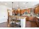 Well-lit kitchen with granite countertops, stainless steel appliances, and a convenient center island with bar seating at 9588 Firenze Way, Highlands Ranch, CO 80126