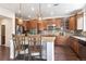 Beautiful kitchen featuring stainless appliances, a center island with bar seating, and stylish pendant lighting at 9588 Firenze Way, Highlands Ranch, CO 80126