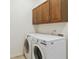 Laundry room featuring a new washer and dryer and overhead cabinets at 9588 Firenze Way, Highlands Ranch, CO 80126