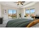 Bright main bedroom featuring a ceiling fan, plush carpet, and sliding glass doors to a balcony with great views at 9588 Firenze Way, Highlands Ranch, CO 80126