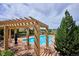 Community pool featuring lounge chairs and umbrellas at 9588 Firenze Way, Highlands Ranch, CO 80126