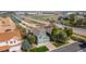 Aerial view of a home with a well-manicured lawn, mature trees, and a convenient location at 22 Apache Plume St, Brighton, CO 80601