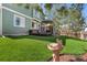 Beautiful backyard featuring a well-maintained lawn, a deck, and a charming bird bath at 22 Apache Plume St, Brighton, CO 80601