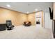 Large finished basement area with seating and an open layout and an entryway into a bedroom or office at 22 Apache Plume St, Brighton, CO 80601