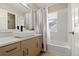 Bathroom features a vanity with sink, mirror, and a shower-tub combination with a bright window at 22 Apache Plume St, Brighton, CO 80601